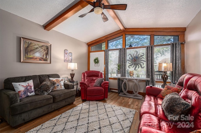 living room featuring ceiling fan, a textured ceiling, hardwood / wood-style flooring, and vaulted ceiling with beams