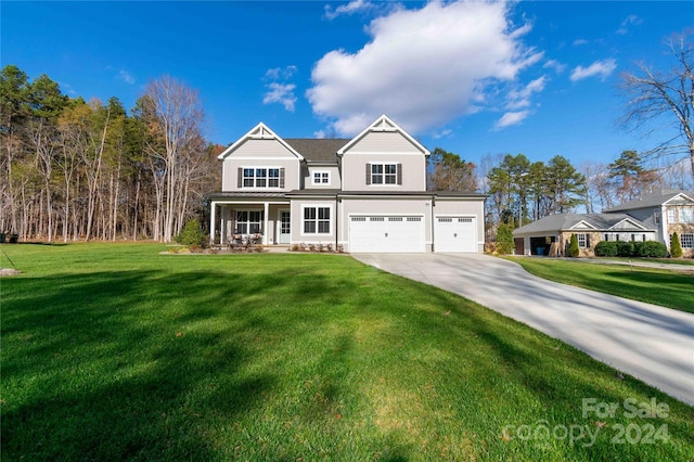 view of front of house featuring a porch, a garage, and a front yard