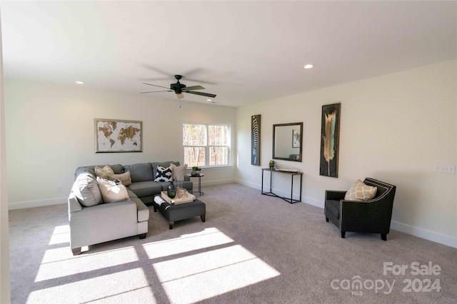 living room featuring ceiling fan and light colored carpet