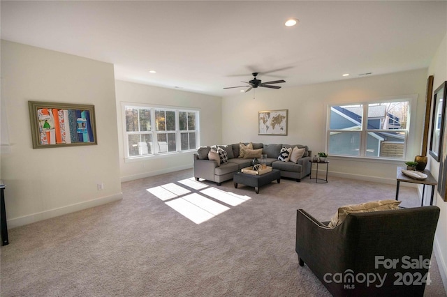 living room with light carpet and ceiling fan