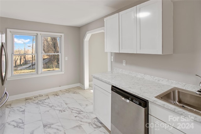 kitchen with dishwasher, white cabinetry, light stone countertops, and sink