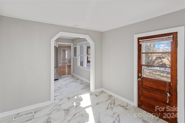 entrance foyer featuring ornamental molding