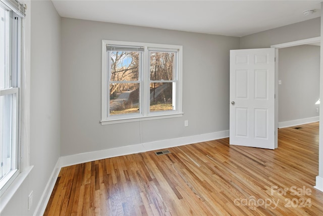 spare room with light hardwood / wood-style flooring