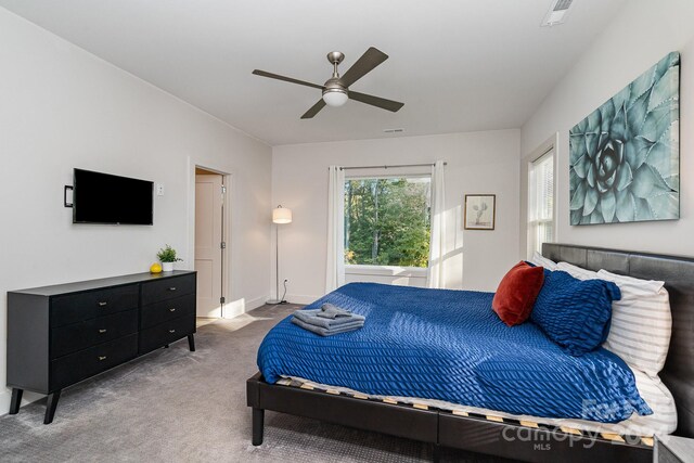 bedroom featuring ceiling fan and light carpet