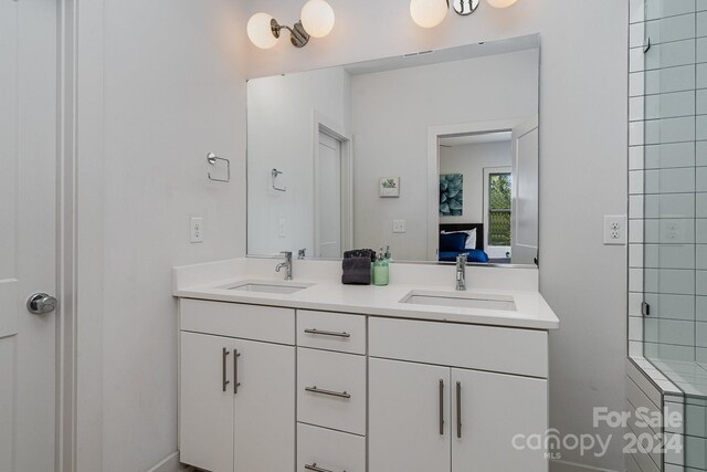 bathroom featuring vanity and a shower with door