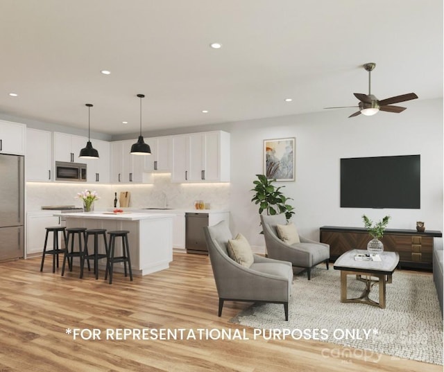 living area featuring light wood-style floors, recessed lighting, and ceiling fan