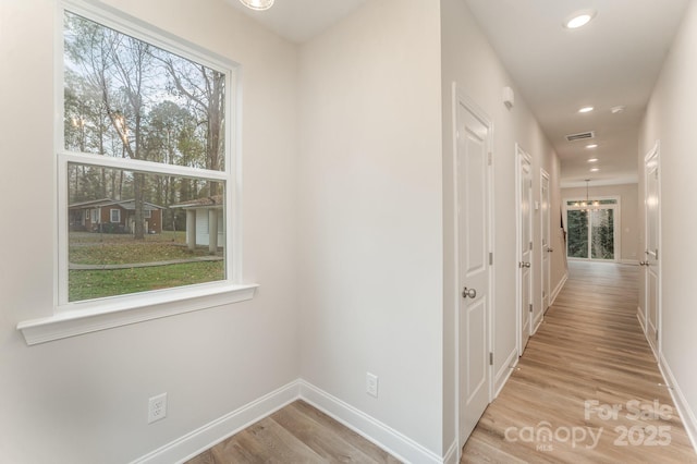 hallway featuring recessed lighting, baseboards, visible vents, and light wood finished floors