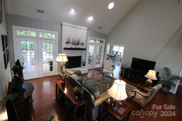 living room featuring a fireplace, dark wood-type flooring, high vaulted ceiling, and french doors