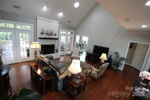 living room featuring a fireplace, french doors, dark hardwood / wood-style flooring, and high vaulted ceiling