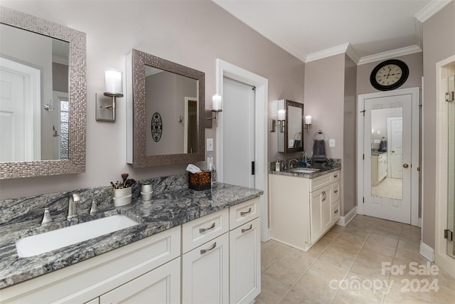 bathroom featuring tile patterned flooring, vanity, and ornamental molding