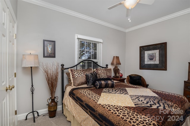 carpeted bedroom with ceiling fan and ornamental molding