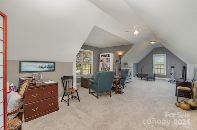 carpeted home office with ceiling fan, plenty of natural light, and vaulted ceiling