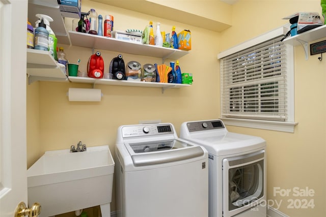 laundry area featuring washer and clothes dryer and sink