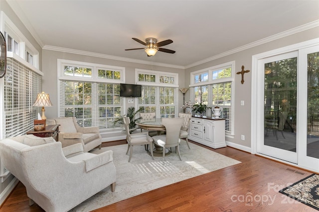 sunroom / solarium featuring ceiling fan