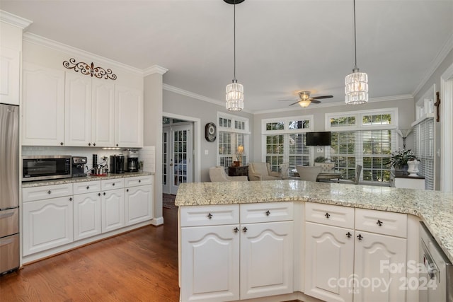 kitchen featuring hardwood / wood-style flooring, white cabinetry, and ornamental molding