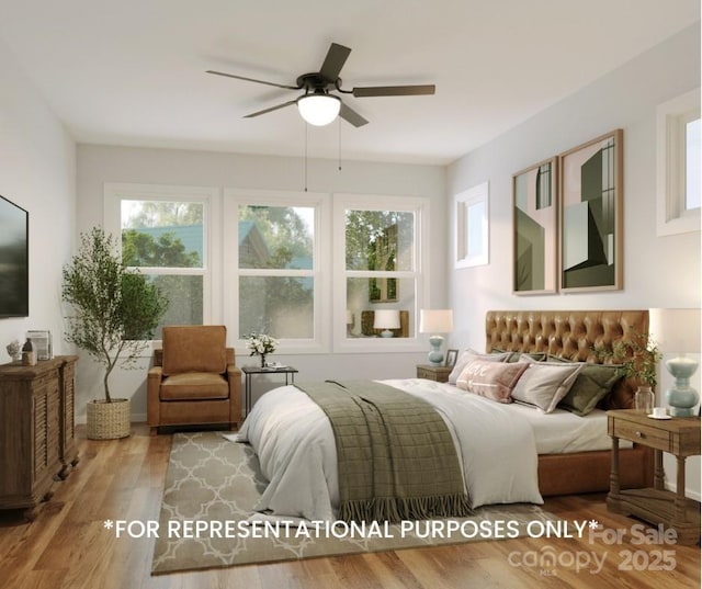 bedroom featuring ceiling fan, multiple windows, and wood-type flooring