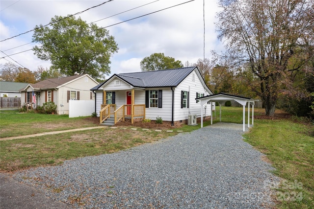 view of front of property featuring covered porch, central air condition unit, and a front yard