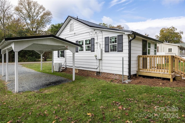 view of property exterior featuring a lawn and a wooden deck