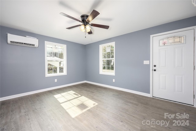 foyer entrance with ceiling fan, dark hardwood / wood-style flooring, and a wall mounted air conditioner