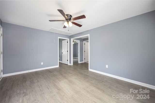 empty room with hardwood / wood-style flooring and ceiling fan