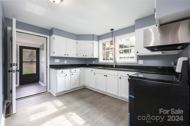 kitchen with white cabinets, a healthy amount of sunlight, ventilation hood, and black range with electric stovetop