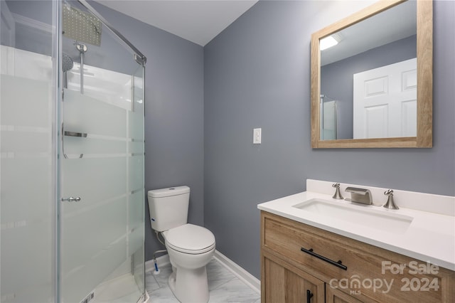 bathroom featuring toilet, an enclosed shower, and vanity