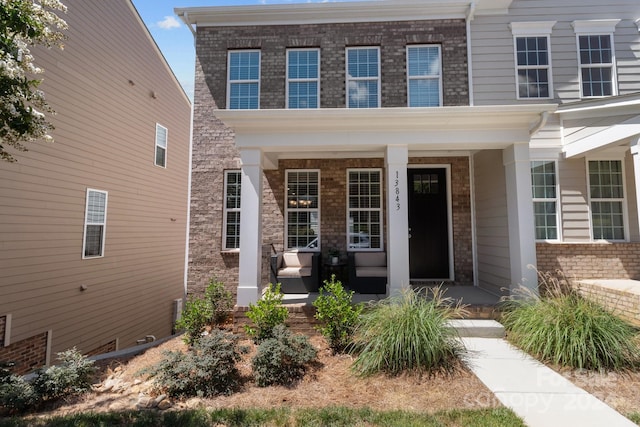 doorway to property with covered porch