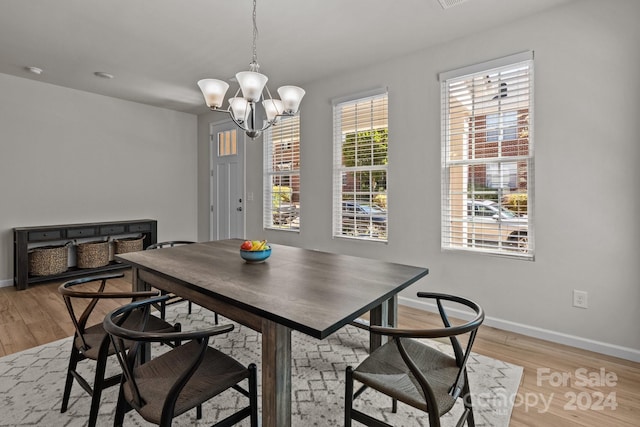 dining room featuring light hardwood / wood-style flooring and a notable chandelier