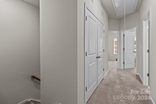 hallway with light colored carpet