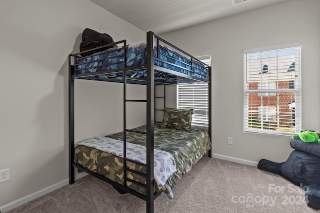 bedroom with multiple windows and carpet flooring