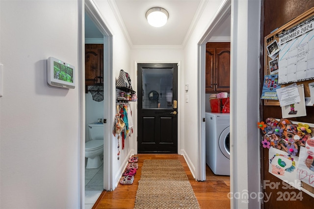 laundry area with washer / clothes dryer, cabinets, light hardwood / wood-style floors, and crown molding