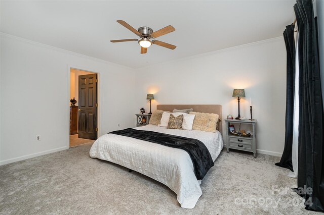 carpeted bedroom with ceiling fan and crown molding