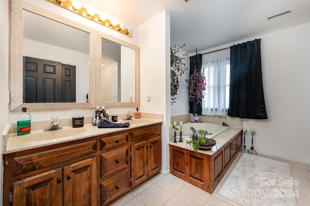 bathroom with a bath, tile patterned flooring, and vanity