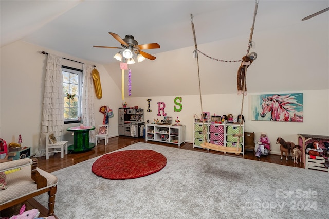 game room with dark hardwood / wood-style floors, ceiling fan, and vaulted ceiling