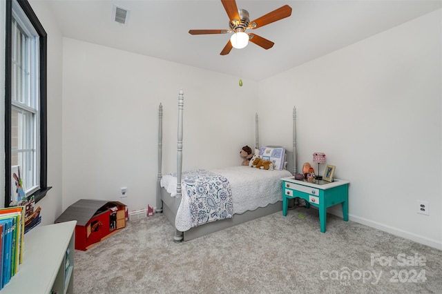 bedroom featuring ceiling fan and light carpet