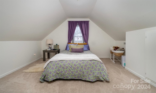 carpeted bedroom featuring lofted ceiling