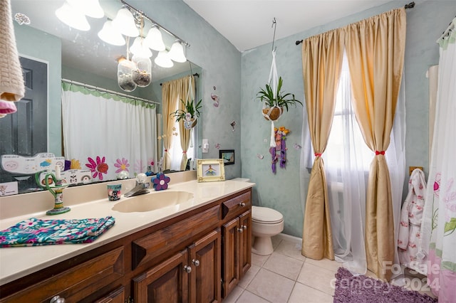 bathroom featuring toilet, vanity, and tile patterned floors