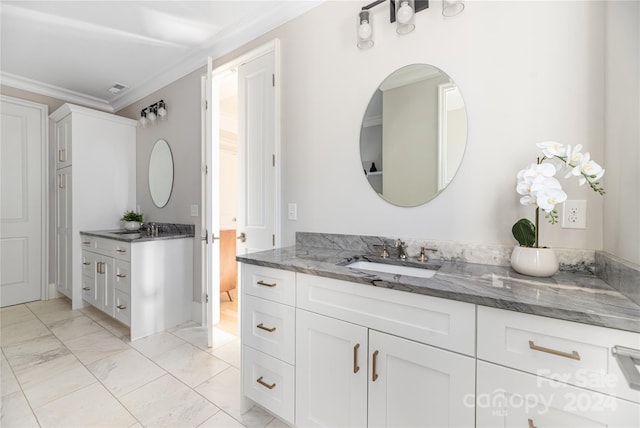 bathroom with vanity and ornamental molding