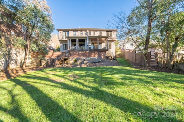 back of property with a balcony and a lawn