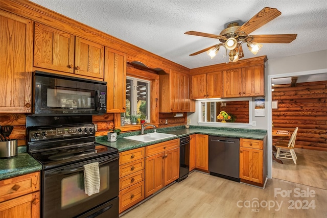 kitchen featuring ceiling fan, sink, light hardwood / wood-style flooring, a textured ceiling, and black appliances