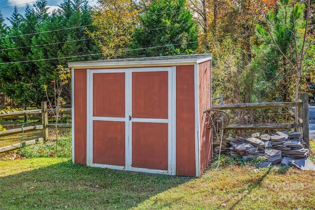 view of outdoor structure featuring a lawn