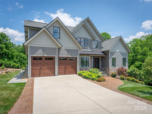 craftsman-style house with a front lawn and a garage