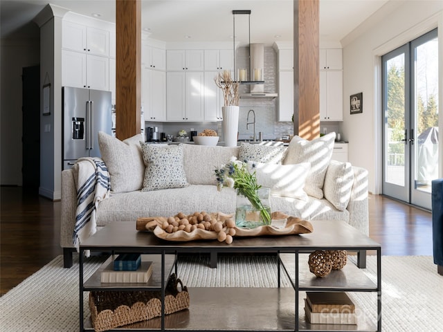 living room featuring french doors, wood-type flooring, and sink