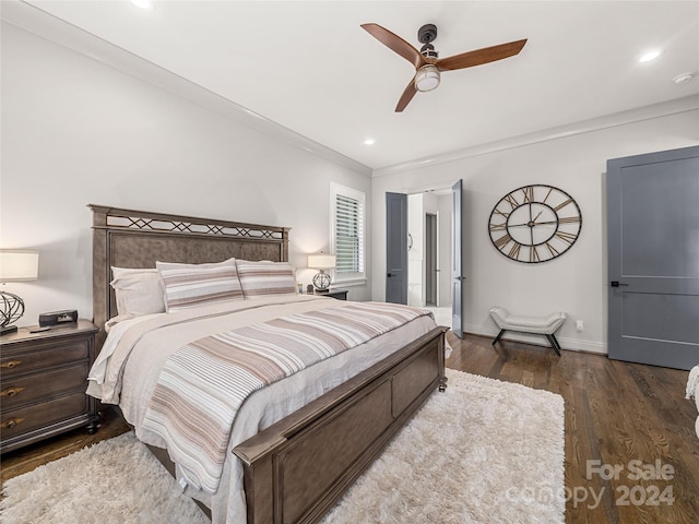 bedroom featuring ornamental molding, dark hardwood / wood-style floors, and ceiling fan