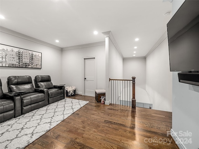 home theater with ornamental molding and dark hardwood / wood-style floors