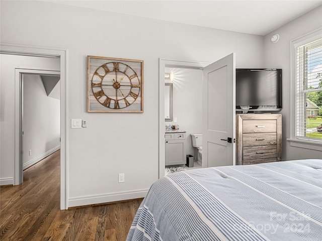 bedroom with dark hardwood / wood-style floors