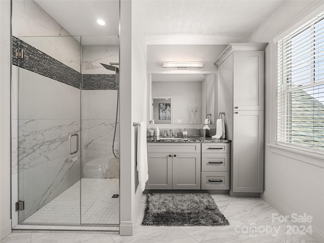 bathroom featuring vanity and a shower with door