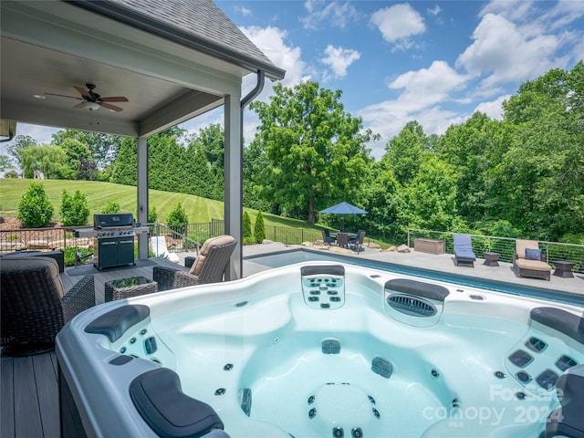 view of swimming pool with a hot tub, grilling area, and ceiling fan