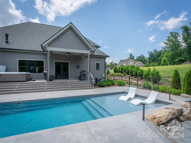 view of swimming pool with a patio and ceiling fan