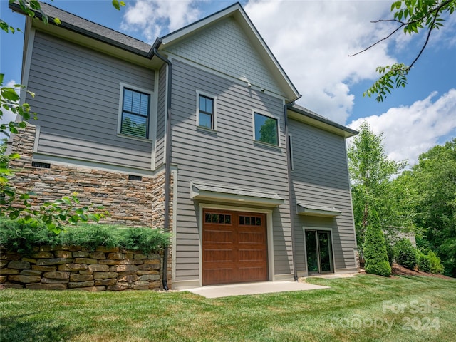 exterior space featuring a garage and a yard